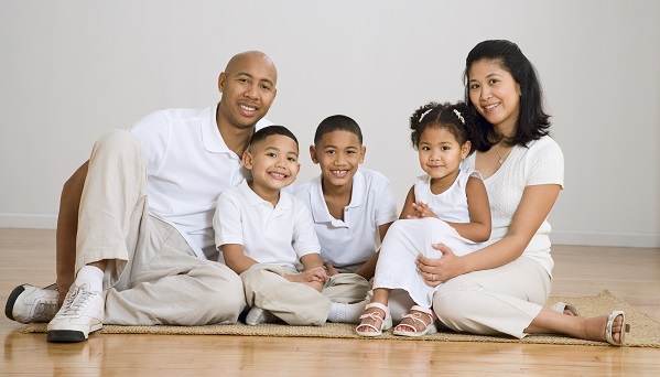Portrait of multi-ethnic family on floor